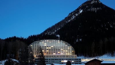 The Intercontinental Hotel is seen behind a farmhouse in Davos, Switzerland. Reuters