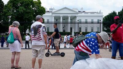 People gather on a section of Pennsylvania Avenue that was reopened to the public in front of the White House in Washington, DC.