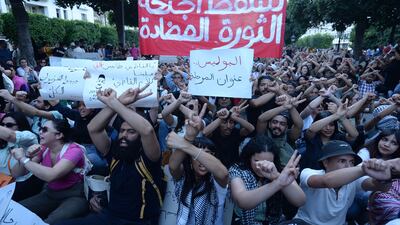 Tunisians block a street during a demonstration in Tunis. AFP