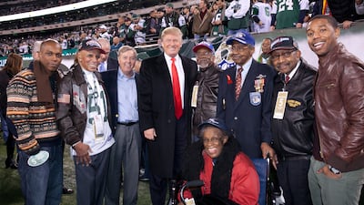 Mr Graham with Donald Trump, now US President, and, from left, actor Leslie Odom Jr, Tuskegee airmen Dr Roscoe Brown, Wilfred Difore, Floyd Carter and Dabney Ian Montgomery, and actor Michael B Jordan, during the NFL And Red Tails' Salute To The Tuskegee Airmen On Veterans' Day Weekend, in New Jersey, 2011. AFP