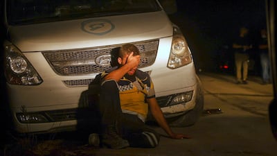 An emergency worker exhausted after battling to extinguish a wildfire near the town of Rabia, in Syria's Latakia countryside. AP
