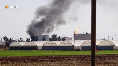 Smoke rises following an air strike on an oil field in Qamishli, north-east Syria. Reuters
