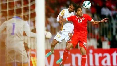 Ismail Suleiman Al Ajmi, left, of Oman vies for the ball against Mohammad Salmeen of Bahrain in the opening match of the Gulf Cup of Nations.