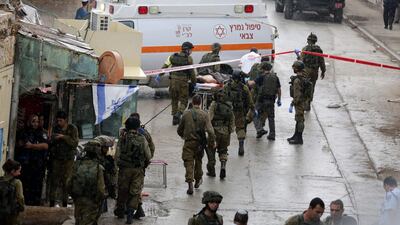 Palestinian Saad Atrazh is carried to an ambulance after being shot by Israeli soldiers near the Ibrahimi Mosque in the Old City of Hebron in the West Bank on October 26, 2015. Abed Al Hashlamoun / EPA