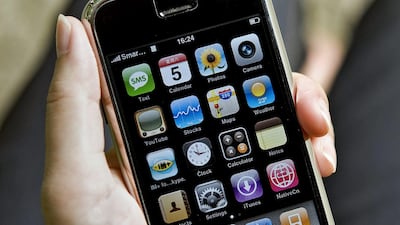 A person holds up an iPhone handset along a street in Hong Kong on July 5, 2008. The iphone changed the way personal computers interacted with people everyday. AFP PHOTO/Andrew ROSS