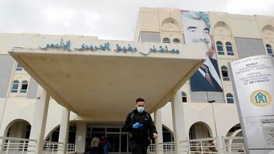 epa08284157 A man wears a face mask as he walks in front of the entrance of the Rafik Hariri University Hospital in Beirut, Lebanon, 10 March 2020. Lebanese Rafic Hariri University Hospital confirmed on 10 March its first death from coronavirus, the Health Ministry confirmed that the patient was a 56-year-old Lebanese citizen who traveled via airplane from Egypt to Lebanon on 20 February 2020. Lebanon on 10 March saw the largest one-day increase since the first case of coronavirus in Lebanon was announced on 21 February, with eleven new cases confirmed. Lebanon has now confirmed a total of 52 cases, with four in a critical state in the Rafik Hariri University Hospital. EPA/WAEL HAMZEH
