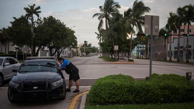 Miami Beach Police Department officers speak at an intersection ahead of the arrival of Hurricane Irma in Miami. Adrees Latif / Reuters