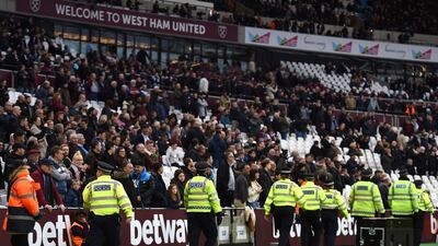 Police secure the area after a pitch invader ran onto the pitch during the English Premier League match between Burnley and West Ham at the Olympic London Stadium. Daniel Hambury / PA via AP