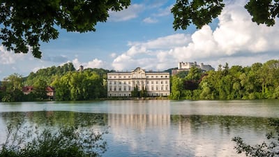 Leopoldskron Palace where the Von Trapp family lived in Sound of Music. In the background is Fortress Hohensalzburg. The city made famous by The Sound Of Music is now host to a new kind of refugees fleeing a dictator. Tourismus Salzburg
