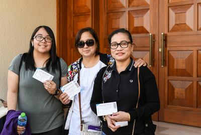 Left, Julian Therese and her mother Alma Therese, along with friend Nicole stand in the queue to collect t-shirts, ahead of the Pope's historic visit. Khushnum Bhandari for The National