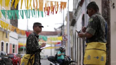 Brazilian soldiers conduct an inspection for the Aedes aegypti mosquito on a street in Recife, Brazil. Ueslei Marcelino / Reuters