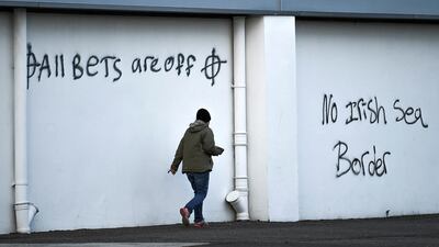 Loyalist graffiti with messages against the Brexit border checks in relation to the Northern Ireland protocol at the harbour in Larne, Northern Ireland February 12, 2021. Reuters