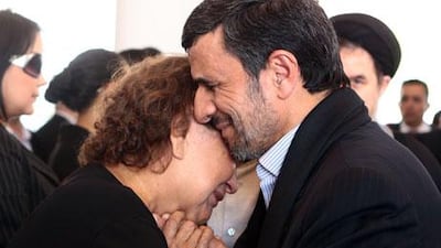 Iran's president, Mahmoud Ahmadinejad, offers his condolences to the mother of late Venezuelan president Hugo Chavez, Elena Frias, during his funeral in Caracas on Friday. Presidencia / AFP / HO