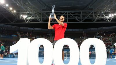 Roger Federer of Switzerland holds the Roy Emerson trophy after winning his 1,000th singles match in the Brisbane International final against Milos Raonic on Sunday. Chris Hyde / Getty Images / January 11, 2015