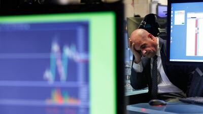 A specialist rests his head in his hand as he works on the floor of the NYSE as traders worry that the spreading coronavirus will threaten global economic growth. AP Photo
