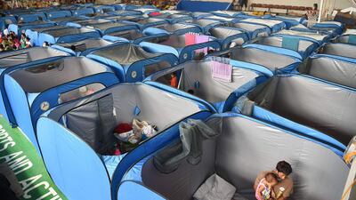 Residents settle into indoor tents at an evacuation centre in Tagaytay City. AFP