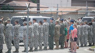 US soldiers and people salute to vehicles transporting the remains of US soldiers. Getty Images