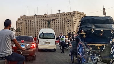 A policeman stops traffic traversing the roundabout in the Egyptian capital Cairo's central Tahrir Square on September 21, 2019. AFP