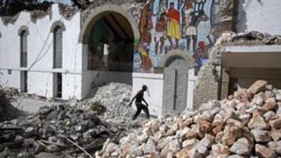 A man walks in the rubble of a collapsed building after the January 12 earthquake.