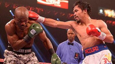 Timothy Bradley of US, left, defends against Manny Pacquiao of Philippines during their WBO World Welterweight Championship title match at the MGM Grand Arena in Las Vegas, Nevada on April 12, 2014. AFP PHOTO /JOE KLAMAR