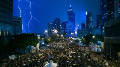 A lightning strike is seen over skyscrapers as demonstrators gather outside the central government complex as they protest during a heavy rain storm in Hong KongLam Yik Fei/Bloomberg