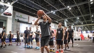 Former NBA player Peja Stojakovic goes up for a shot as he does a clinic with kids at Dubai Sports World on Tuesday. Antonie Robertson / The National
