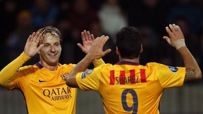Barcelona’s Ivan Rakitic celebrates his goal with Barca teammate Luis Suarez on Tuesday night in their Champions League win over Bate Borisov. Maxim Malinovsky / AFP