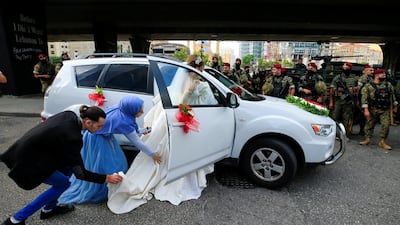 A bride gets into a car during a protest against the government performance and worsening economic conditions, in Beirut, Lebanon. EPA