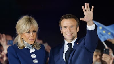 Brigitte, wearing a blue military-style jacket with silver buttons and blue trousers, shortly after her husband Emmanuel Macron's presidential re-election victory on April 24, 2022. AFP