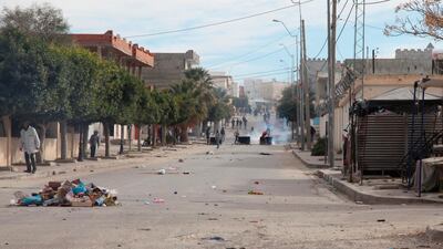 Protesters throw rocks at policemen during a demonstration. AFP