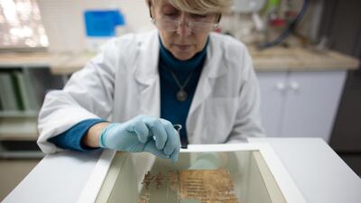 A conservation analyst prepares fragments of the Dead Sea scrolls to be photographed in 2012 in Jerusalem. Getty Images