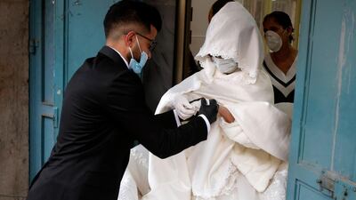 Palestinian bride Bara'a Amarneh and her groom Imad Sharaf leave the beauty salon. AFP