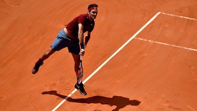 Roger Federer of Switzerland serves in his match against Dominic Thiem of Austria during their match at the Italian Open. Dennis Grombkowski / Getty Images