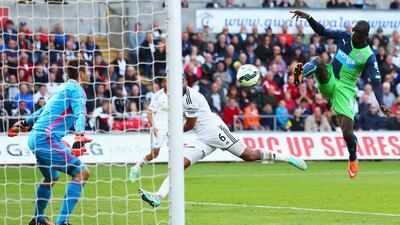 Papiss Cisse of Newcastle United scores their second goal past goalkeeper Lukasz Fabianski of Swansea City during their Premier League match on Saturday in Swansea. Michael Steele / Getty Images