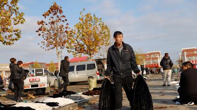 A man carries mink furs at an open air market in Li county, Hebei province, China. Reuters