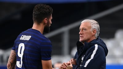 Olivier Giroud speaks with France's coach Didier Deschamps as he leaves the pitch. AFP