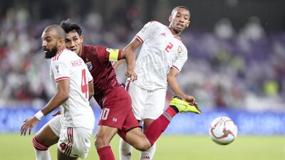 Ali Hassan Ali Salmin, right, of UAE and Teerasil Dangda battle of Thailand during the game.
