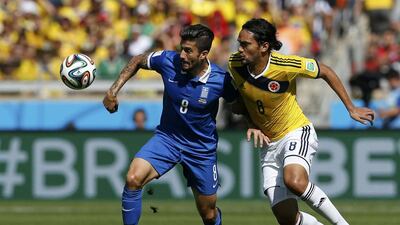 Greece's Panagiotis Kone, left, fights for the ball with Colombia's Abel Aguilar during their 2014 World Cup Group C match on Saturday in Belo Horizonte, Brazil. Sergio Perez / Reuters