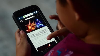 A child reading about the latest Star Wars film, ‘The Force Awakens’. Reel Cinemas began selling tickets for the premier on Wednesday. Frederic J. Brown / AFP Photo