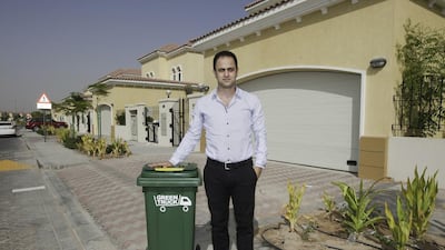 Diya Khalil with one of his Green Truck bins at Jumeirah Park. His new company offers recycling to private villa communities. Jaime Puebla / The National