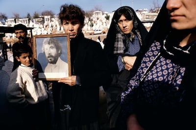 Photographs of 20-year-old Kamaran Abdullah Saber are held by his family at a cemetery in the Kurdistan region of Iraq. He was killed in July 1991 during a student demonstration against Saddam Hussein. Magnum Photos