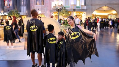 People pose with their capes at Warner Bros in Abu Dhabi. Pawan Singh / The National