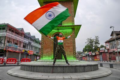 An Akhil Bharatiya Vidyarthi Parishad (ABVP) activist waves India's national flag to mark the country's Independence Day at Lal Chowk in Srinagar on August 15. AFP
