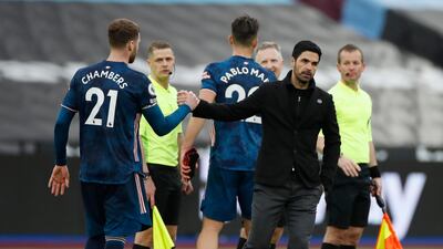 Arsenal's Calum Chambers with manager Mikel Arteta after the match. Reuters
