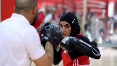 Fahima Falaknaz hits the pads with UAE national team coach Mohammed Al Shebli. Pawan Singh / The National