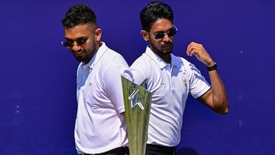 Sri Lanka's captain Dasun Shanaka, left, and teammate Matheesha Pathirana with the 2026 T20 World Cup trophy in Colombo. AFP