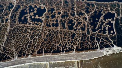 This aerial view shows patterns formed by crystalized minerals on the surface evaporation ponds of the Dead Sea, near the southern Israeli Neve Zohar community village. AFP