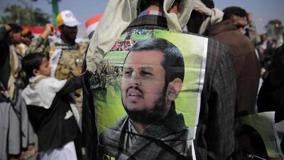 A supporter of Houthi Shiites displays a poster of Abdel Malek Al Houthi, the leader of Yemen's Shiite rebels, on his jacket during a rally to mark the third anniversary of the Houthis' takeover of the Yemeni capital, in Sanaa, Yemen. The rebels launched a ballistic missile at Saudi Arabia just three days after the rally. Hani Mohammed / AP