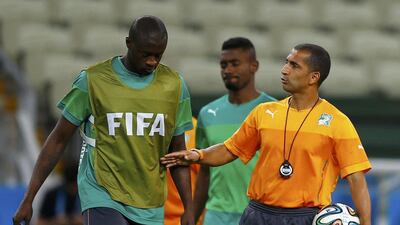Ivory Coast coach Sabri Lamouchi, right, talks to Yaya Toure during a team training session on Monday ahead of their Tuesday match with Greece at the 2014 World Cup in Brazil. Marcelo del Pozo / Reuters / June 23, 2014