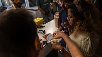 Residents purchase food from one of the stalls